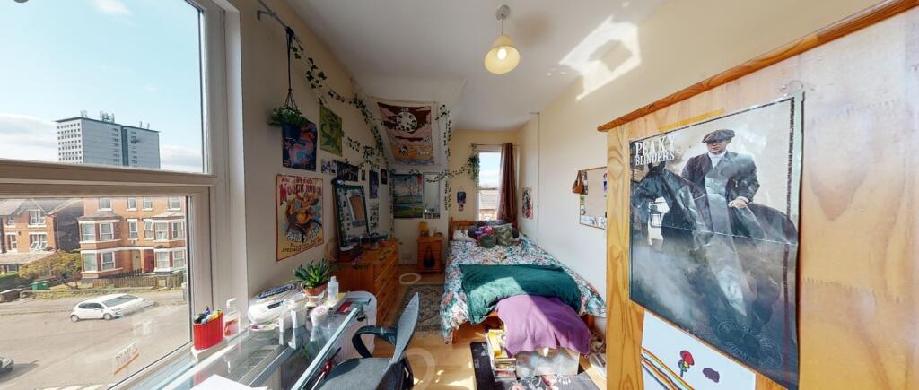 A bright and inviting double bedroom with plent...