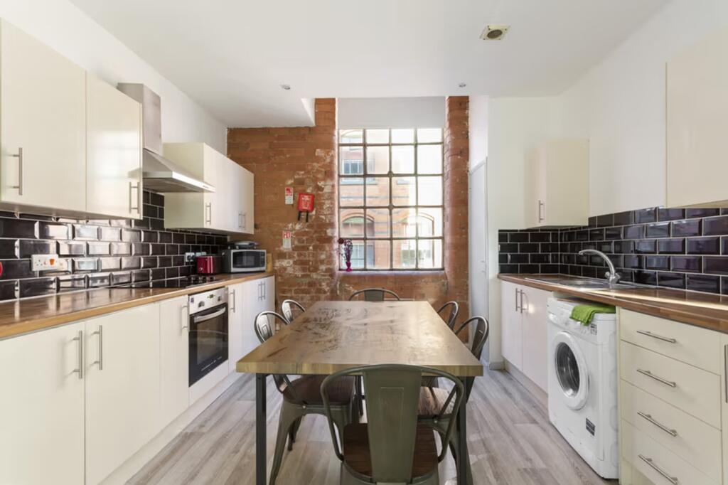 A spacious and modern kitchen featuring ample c...