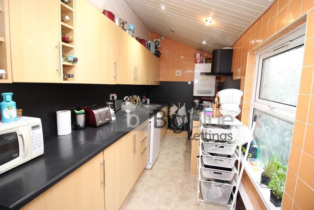 Bright and functional kitchen featuring light w...