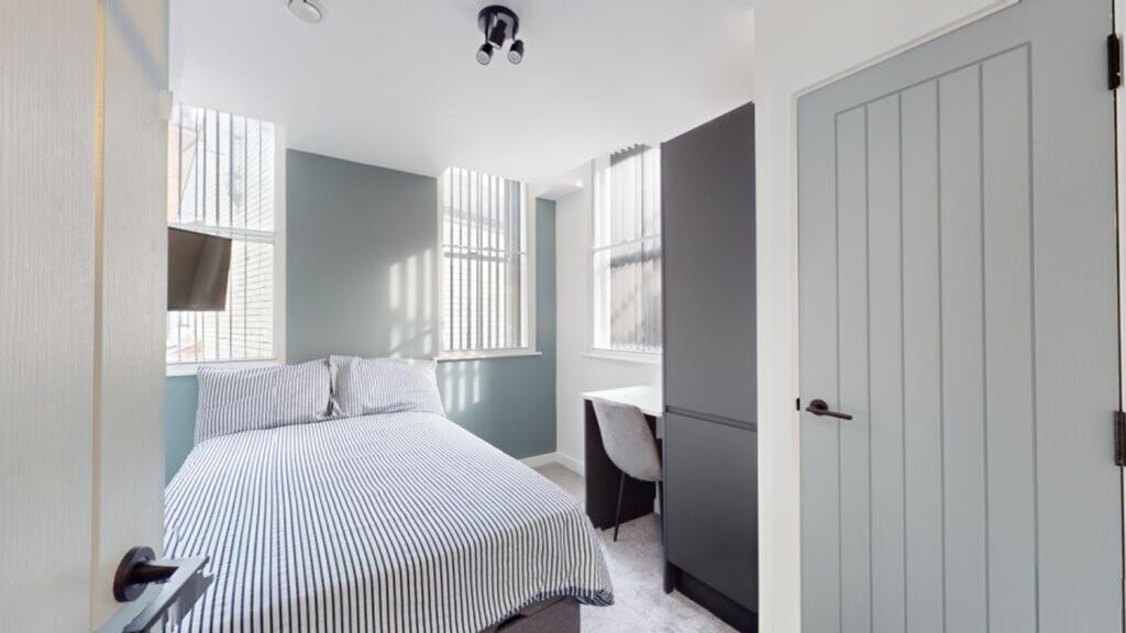 A bright and inviting double bedroom featuring ...