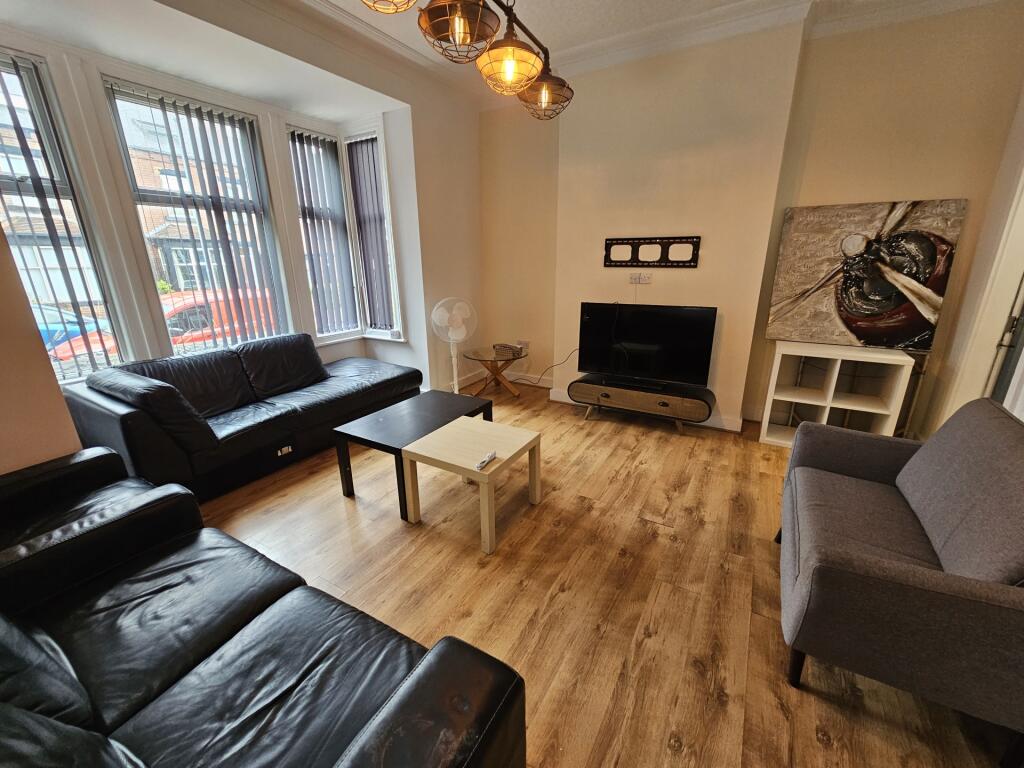 Spacious and well-lit living room featuring lar...