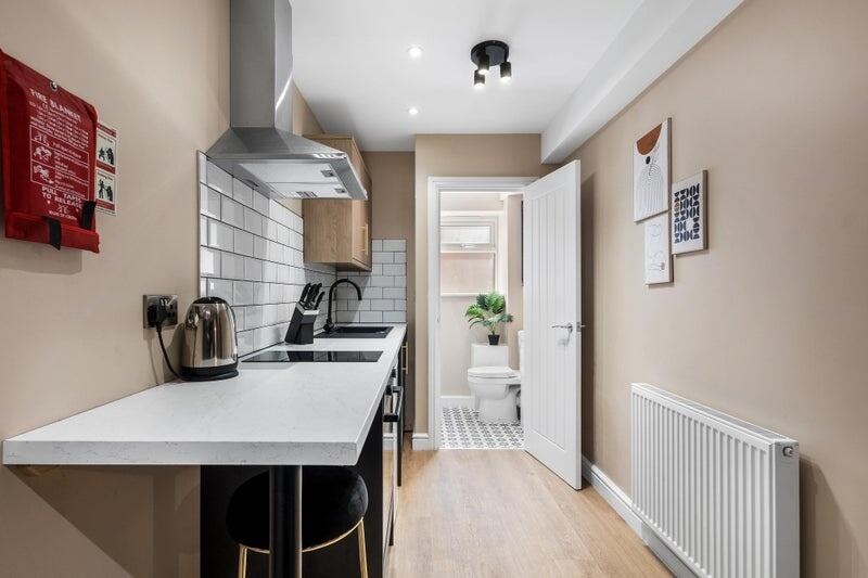 Modern and sleek kitchen featuring a clean whit...