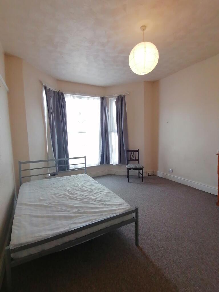 A spacious and bright double bedroom with ample...