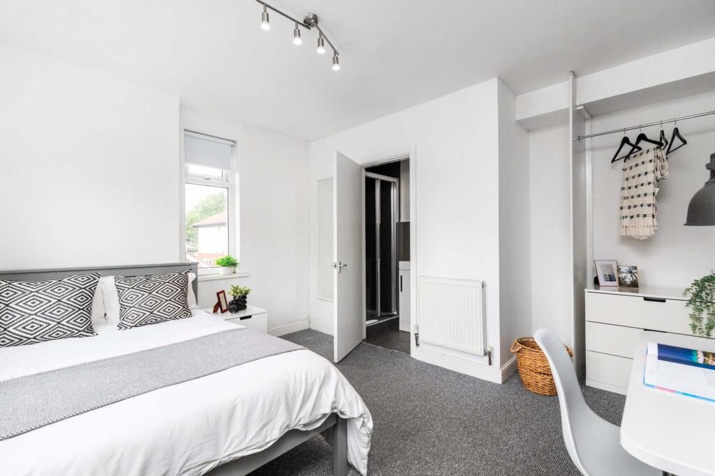 Bright and modern bedroom featuring a double be...