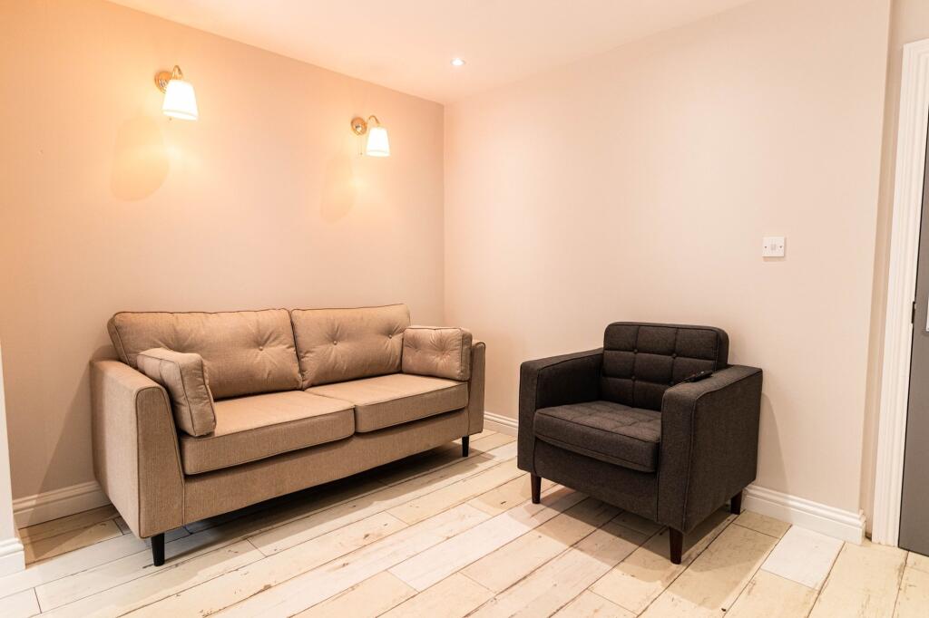 A cozy and well-maintained living room featurin...