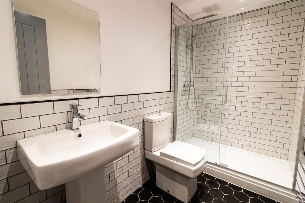 Modern bathroom featuring a large walk-in showe...