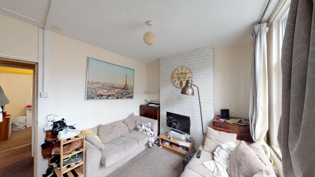A cozy living room featuring comfortable sofas,...