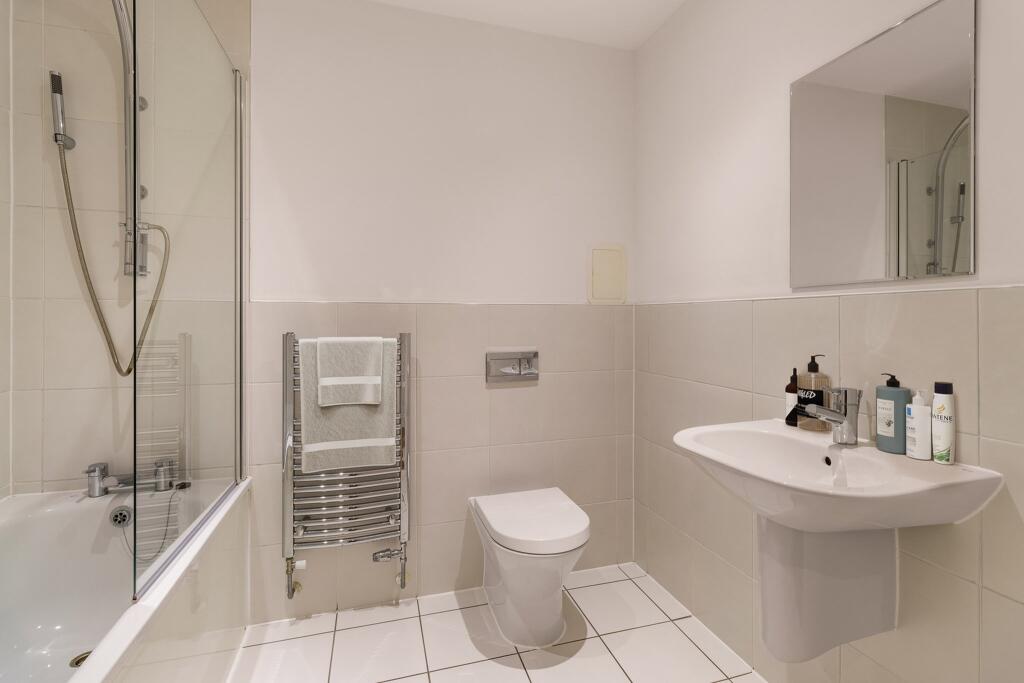 Step into this stylish bathroom with modern amenities and clean lines.