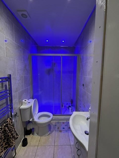 A spacious bathroom featuring a large bathtub, ...