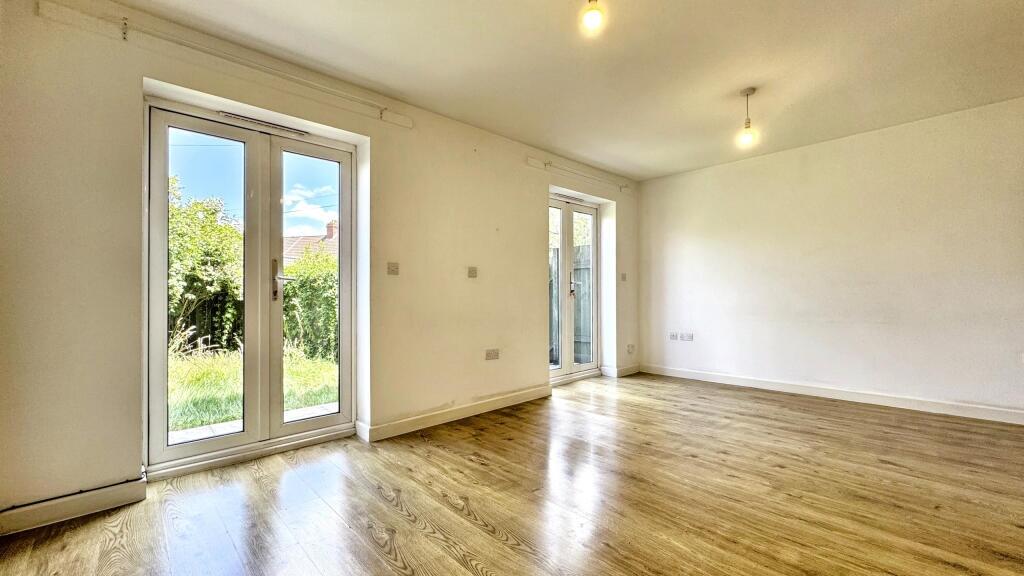 Bright and airy living room featuring large Fre...