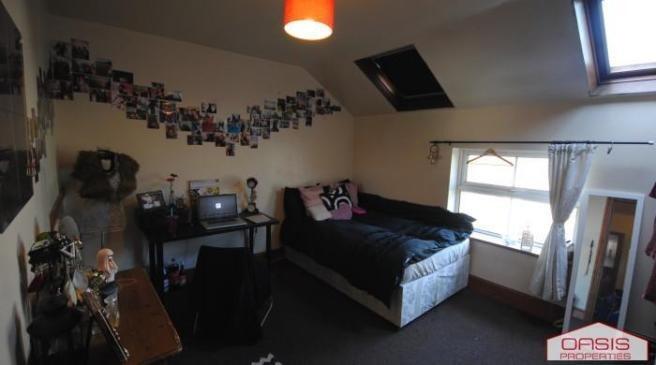 A cozy bedroom featuring a double bed and a win...