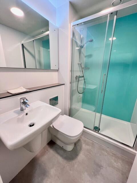 A modern and clean bathroom suite featuring a b...