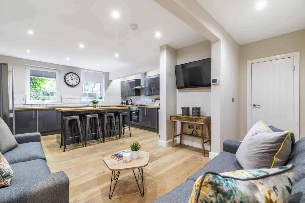 Bright and modern living room featuring comfort...