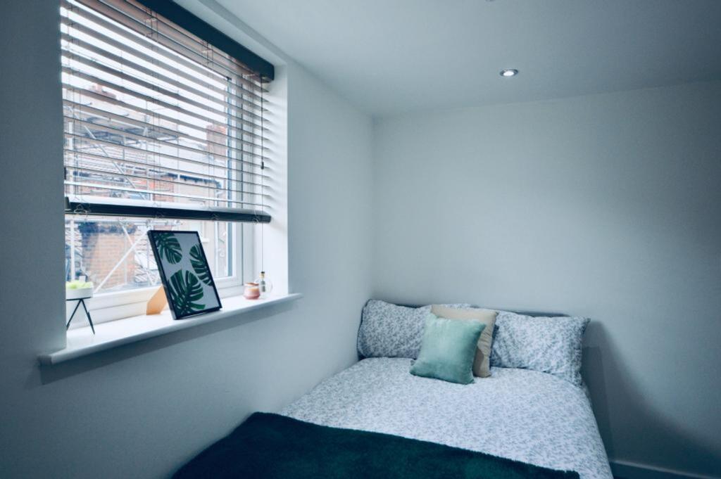 A cozy and bright double bedroom featuring mode...