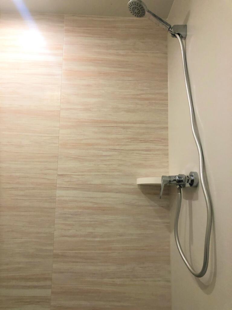 A clean, modern shower area featuring a sleek c...