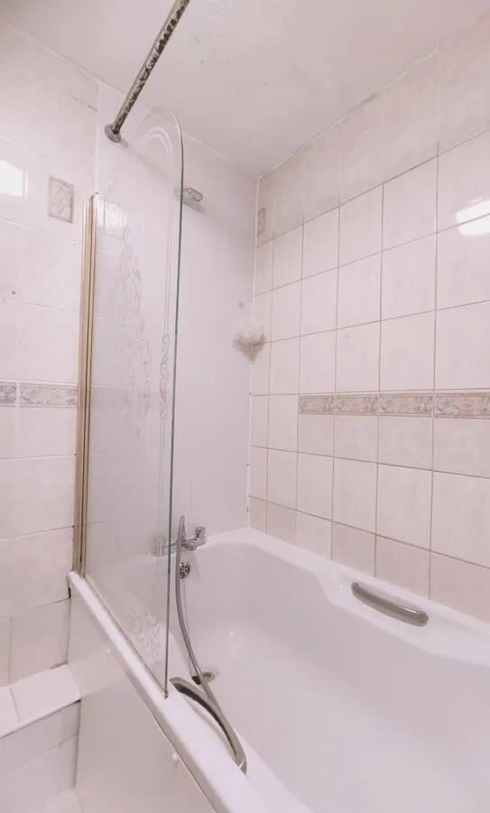 A clean and functional bathroom suite featuring...