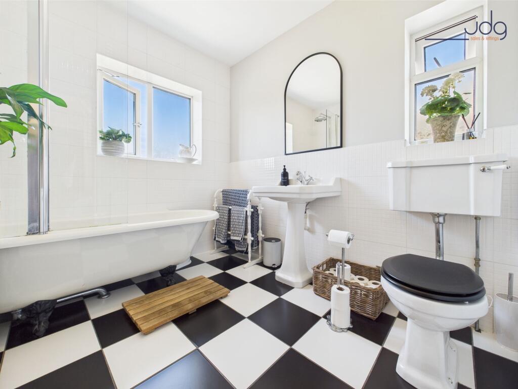 Roll-top bath with claw feet in the family bathroom