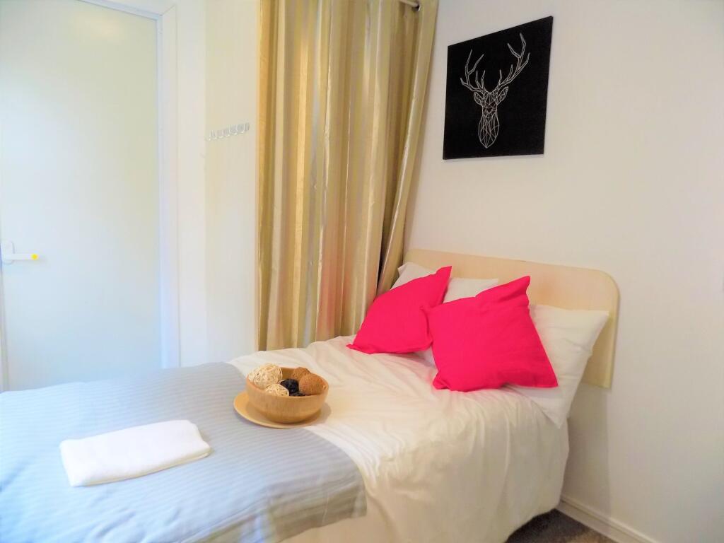 Cozy and inviting single bedroom featuring a ne...