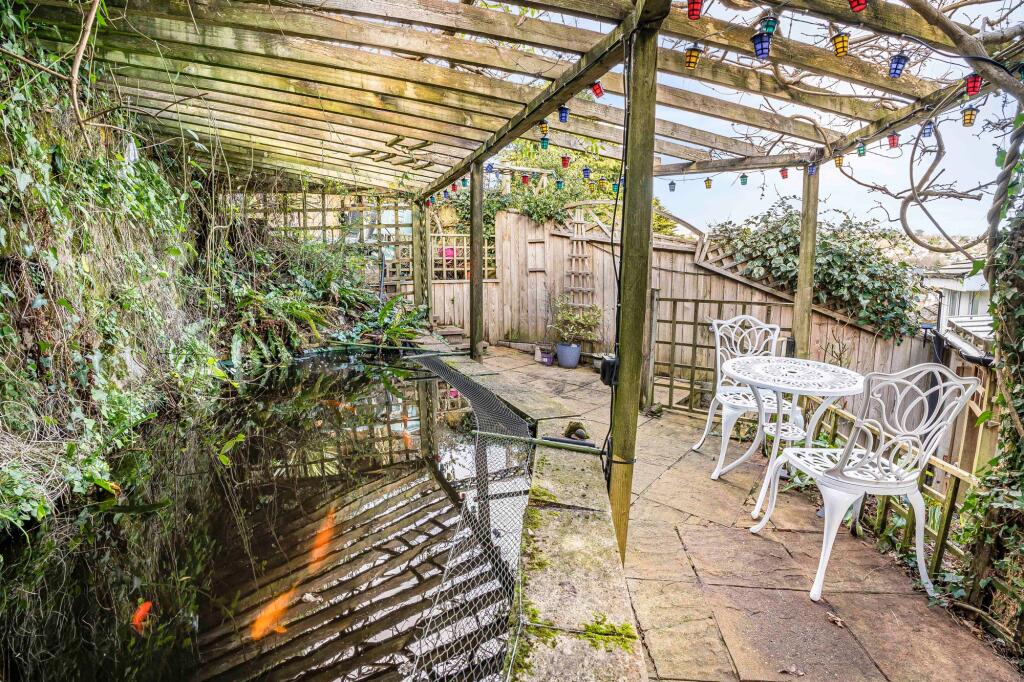 Under cover patio with fish pond