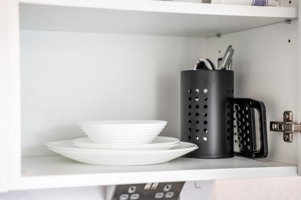 A well-organized kitchen shelf showcasing clean...