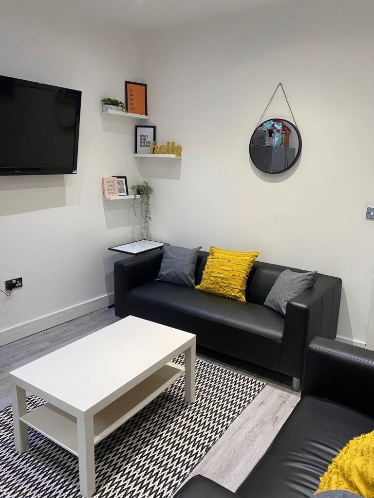 A cozy living room featuring a stylish black so...