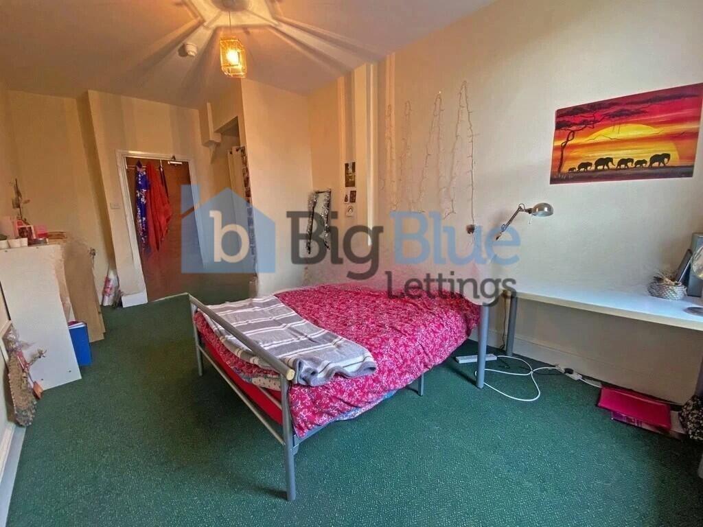 A cozy single bedroom featuring a comfortable m...