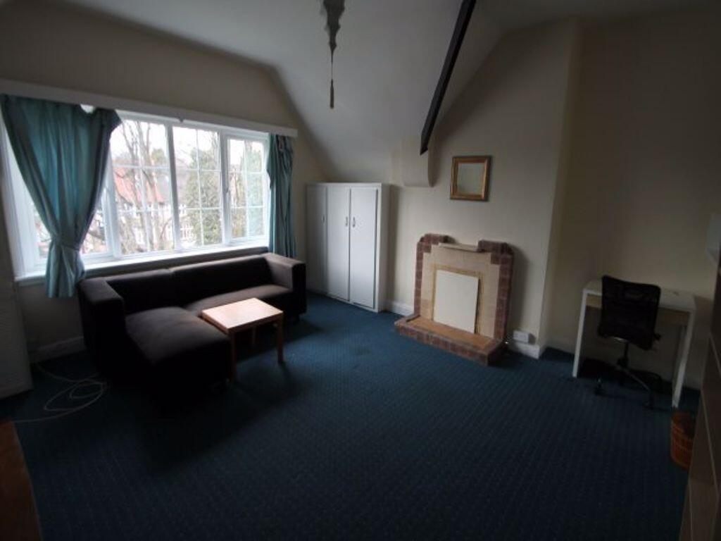 Bright front living room with a large bay windo...