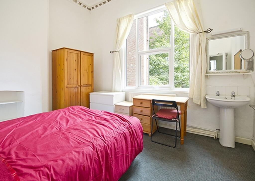 A bright and welcoming double bedroom featuring...