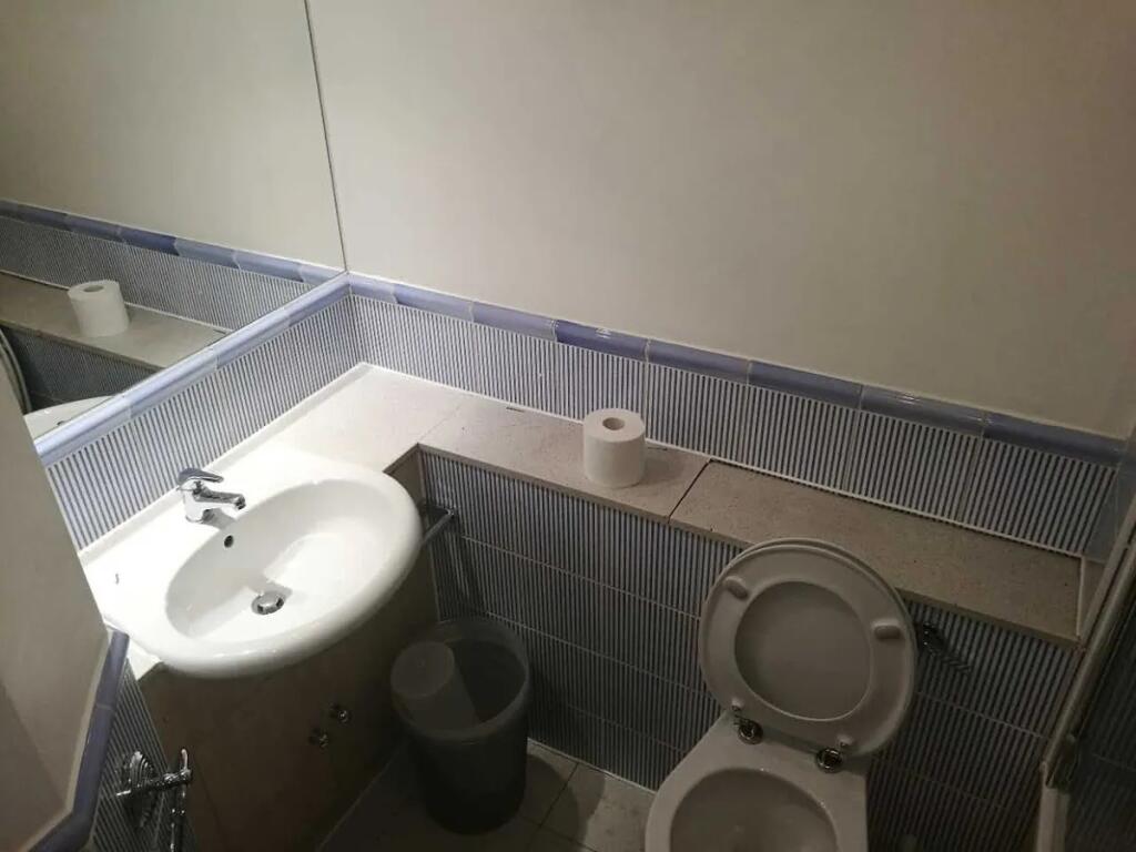 Compact and functional bathroom featuring a cle...