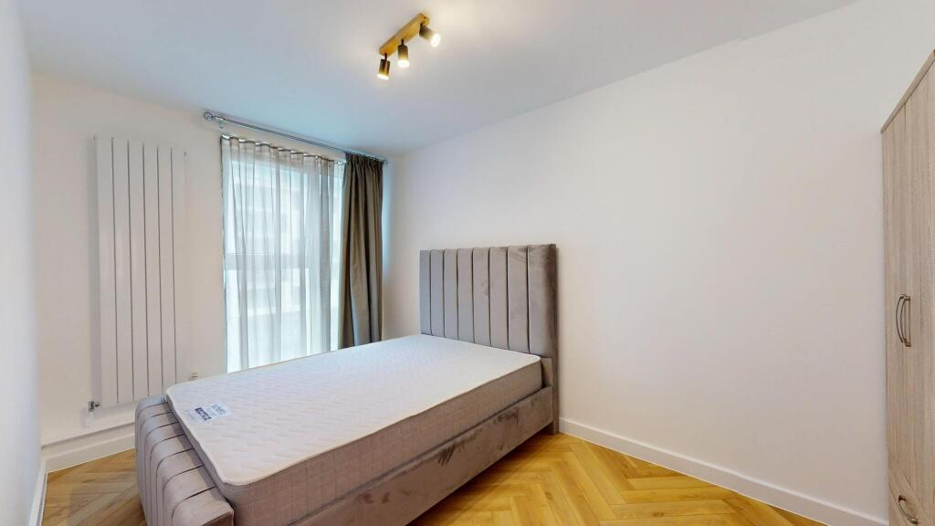 A bright and modern double bedroom featuring a ...