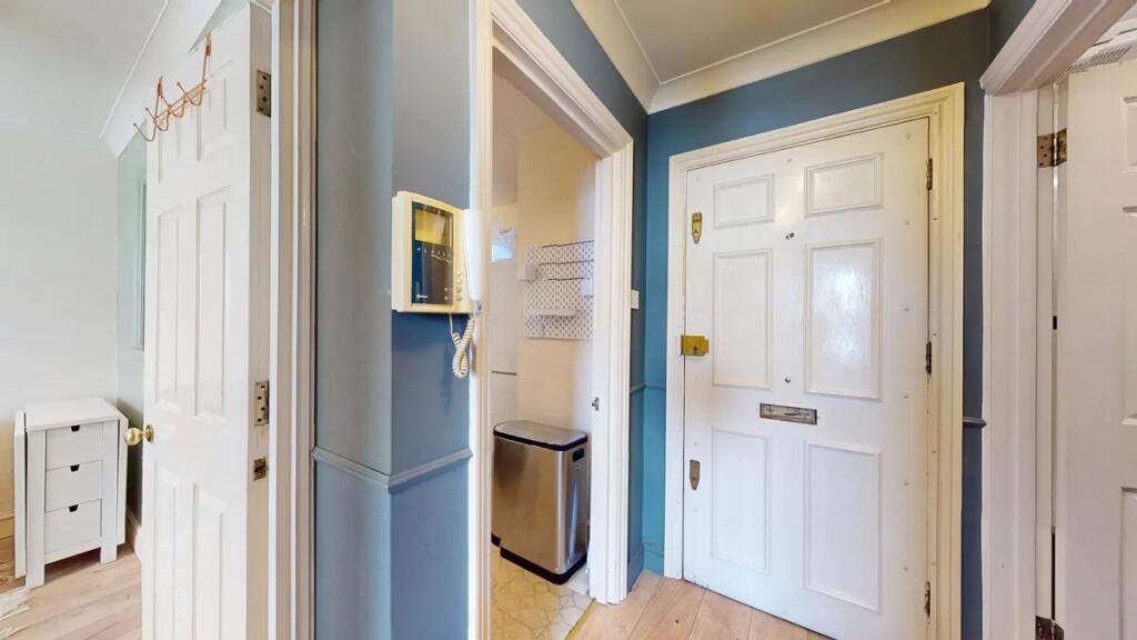 A neat and welcoming hallway featuring a white ...