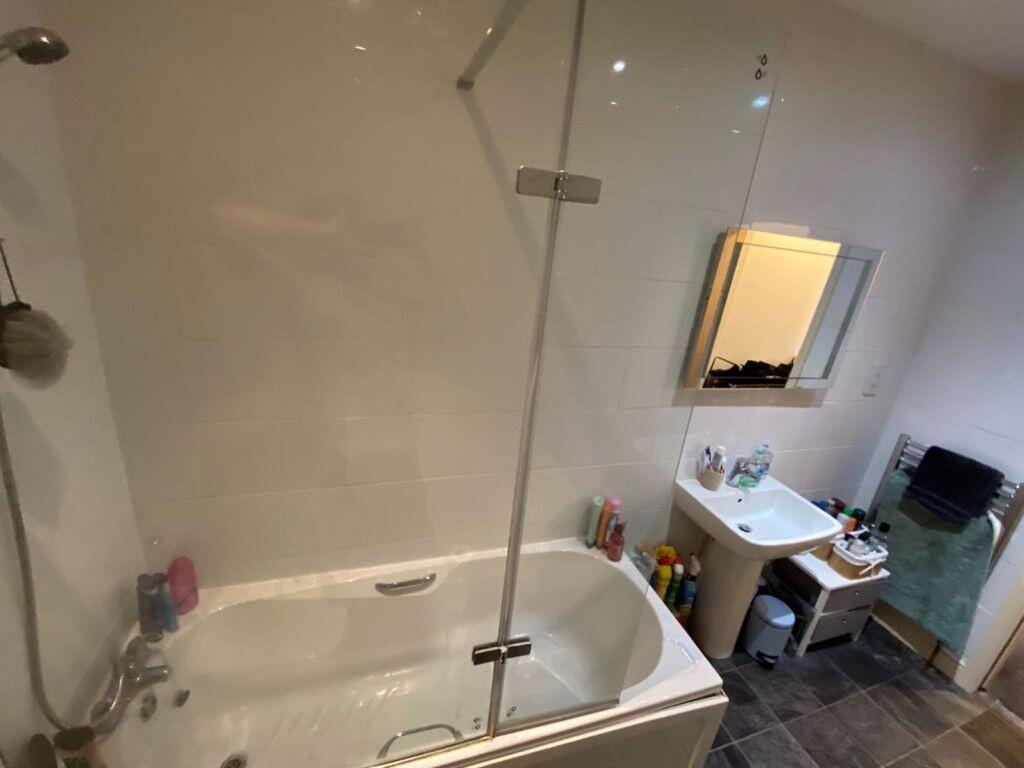 A spacious and clean bathroom suite featuring a...