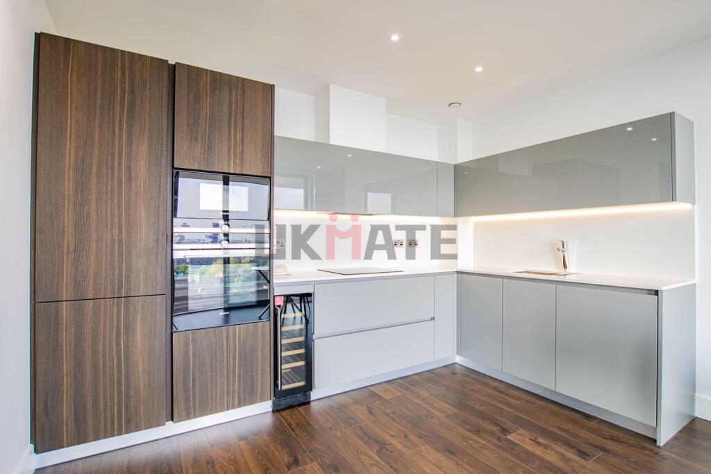 Modern and stylish kitchen featuring sleek whit...