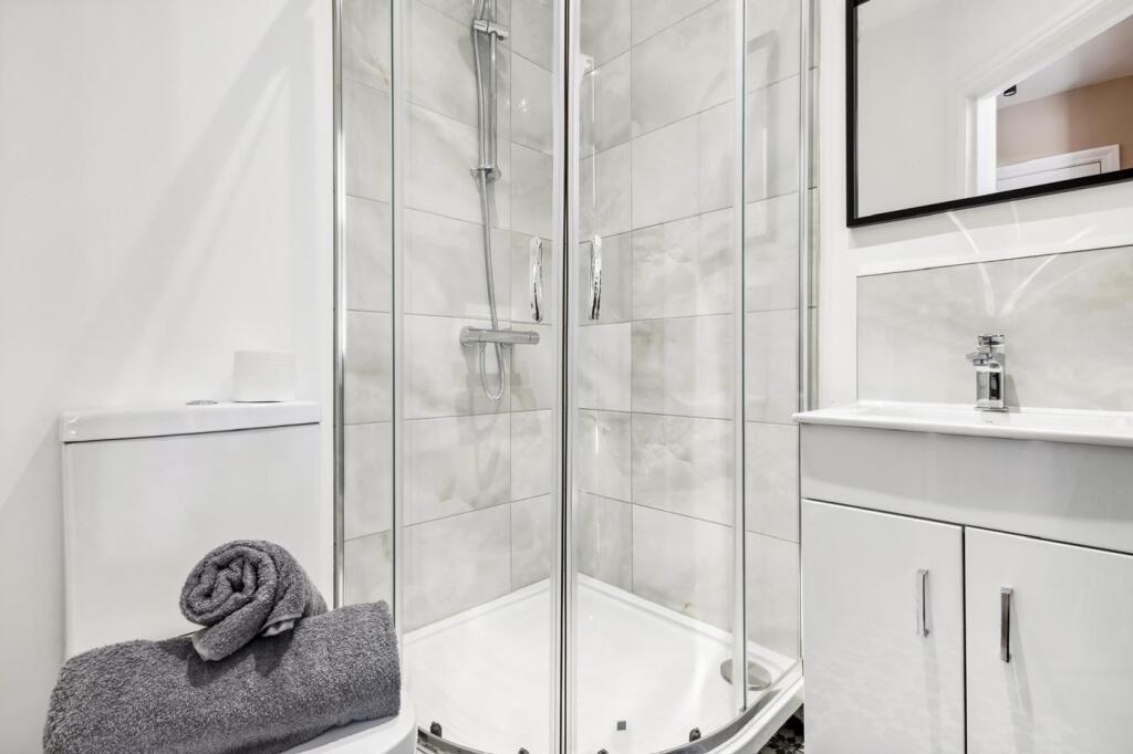 Modern bathroom suite featuring a spacious show...