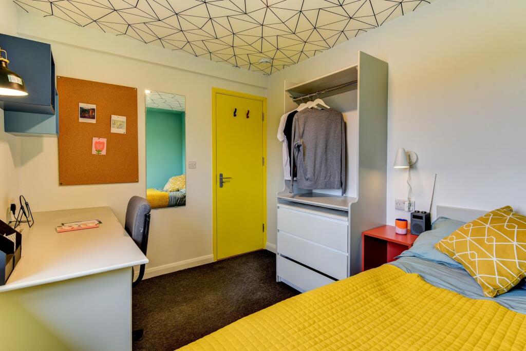A cozy and modern double bedroom featuring a vi...