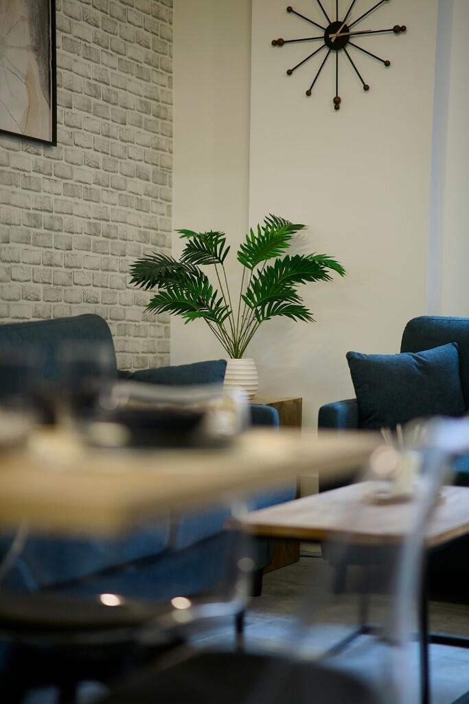 A stylish living room featuring comfortable blu...