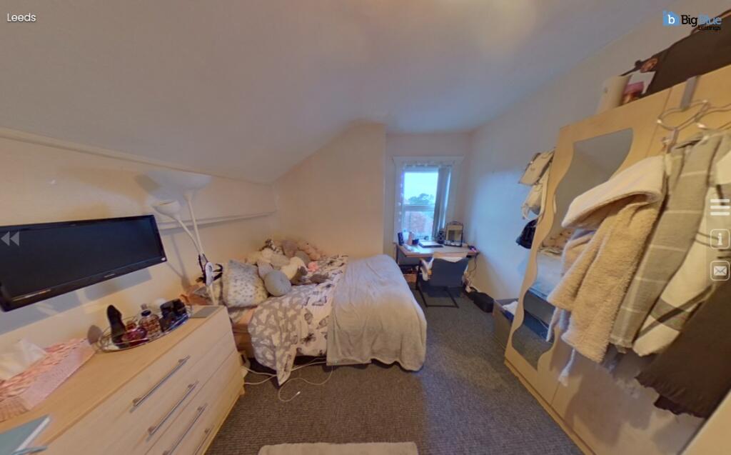 Cozy single bedroom featuring a comfortable bed...