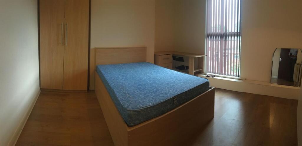 Bright, simply furnished double bedroom with a ...