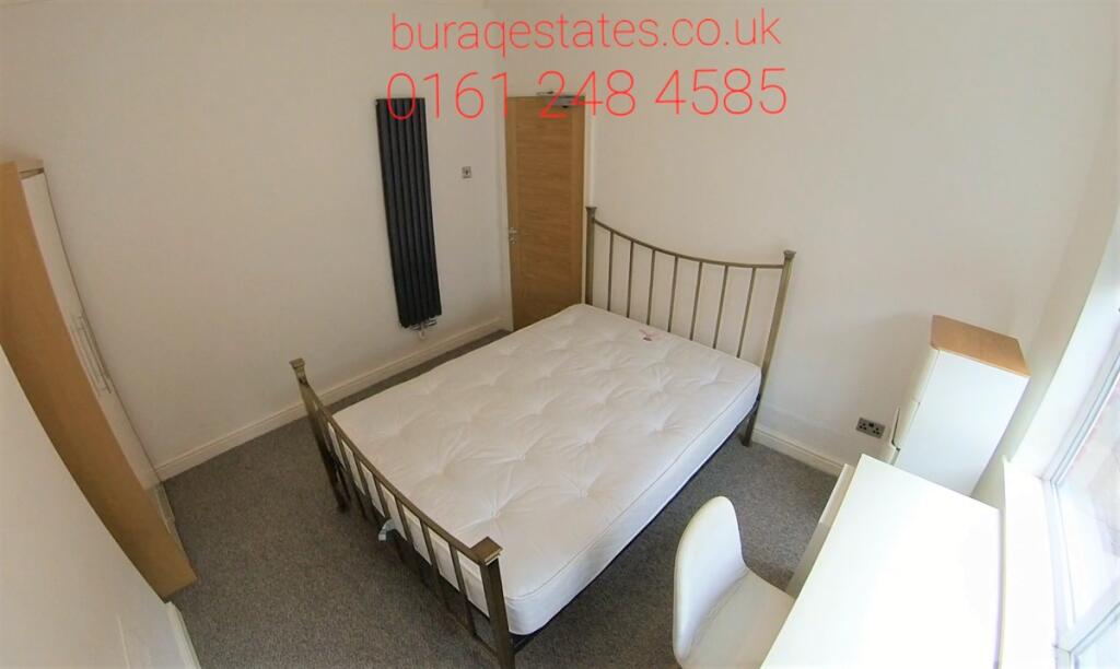 Bright, neutral double bedroom with a metal-fra...