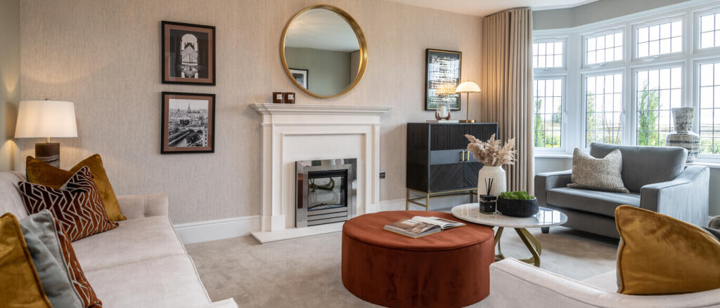 Living room with large bay windows, modern fireplace, wall art, and contemporary furniture including