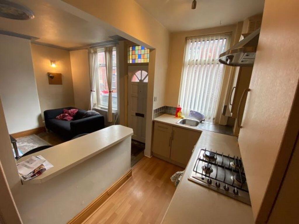 Open-plan living area with a compact fitted kit...