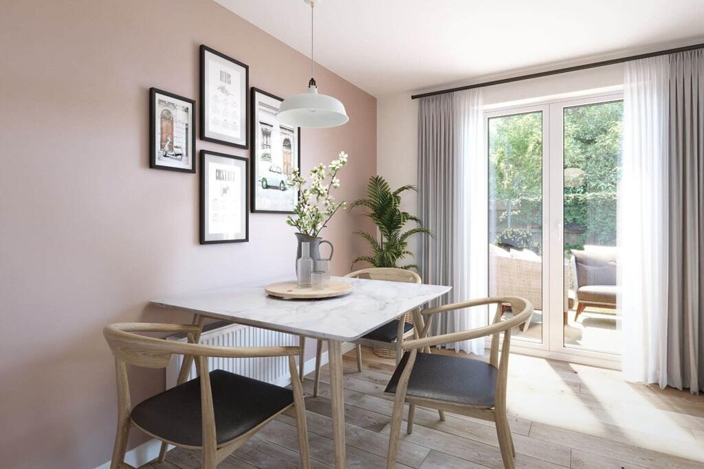 An open-plan kitchen-diner with space for a table and chairs, offering a simple and functional layo