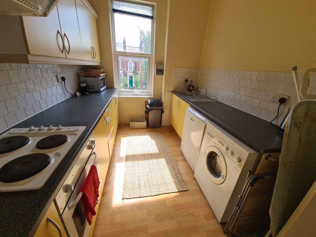 A well-lit, tidy kitchen with modern appliances...