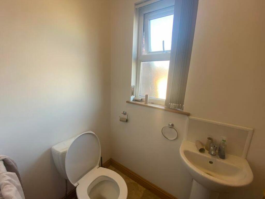 A tidy single toilet with natural light and ess...