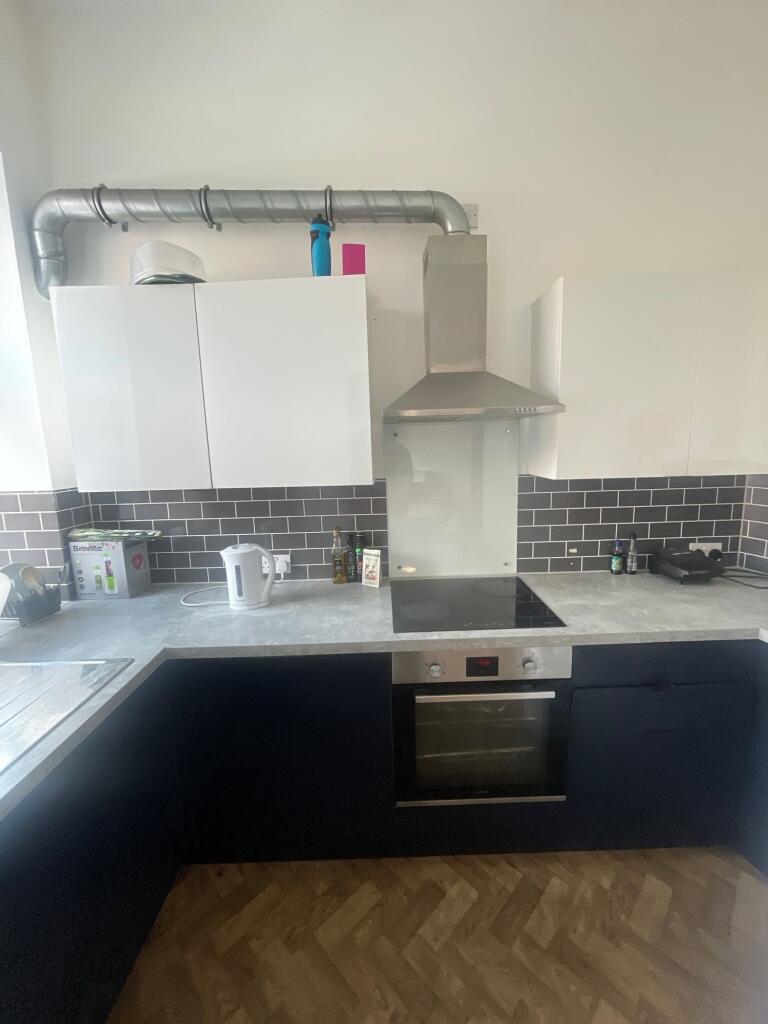 A modern kitchen featuring a sleek electric hob...