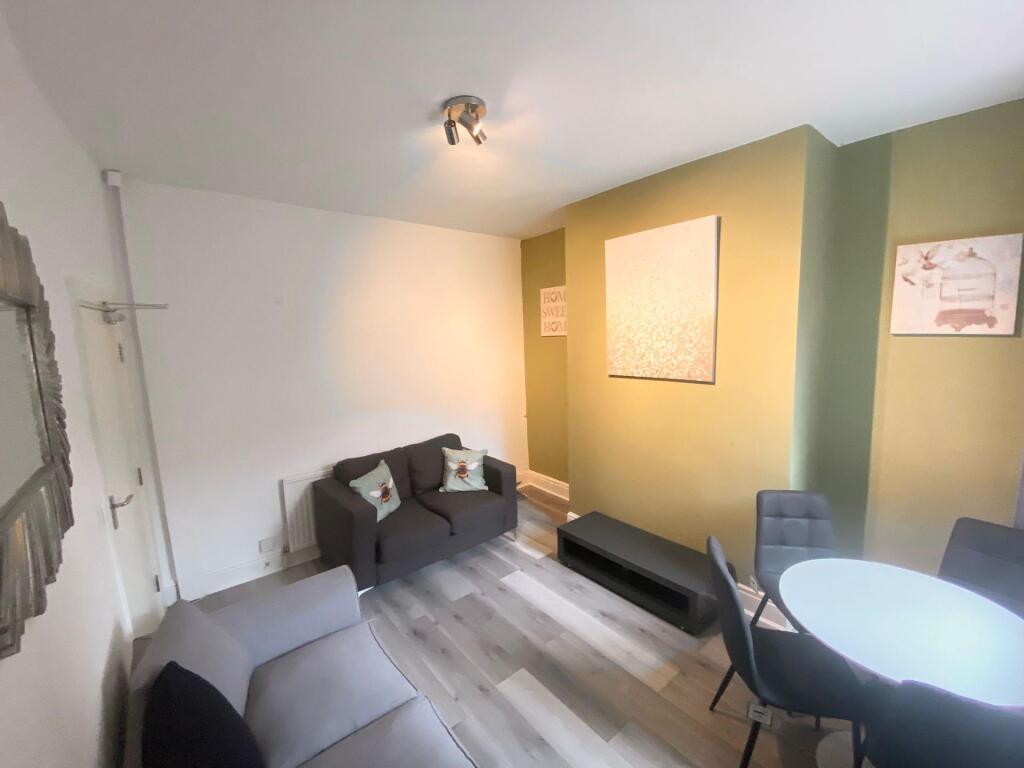 A cozy living room featuring modern grey sofas ...