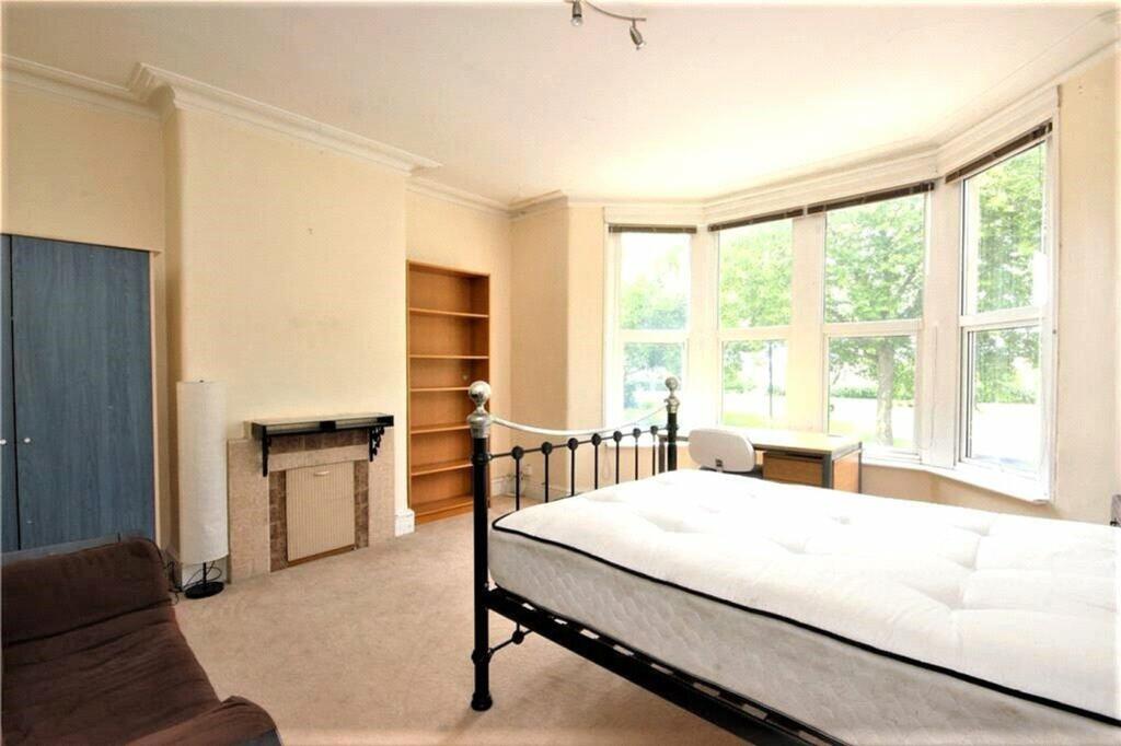 This inviting double bedroom features large win...