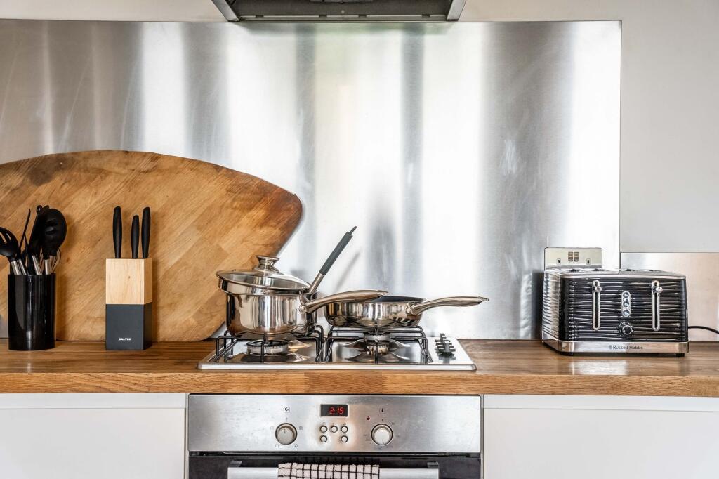 Modern kitchen featuring sleek stainless steel ...