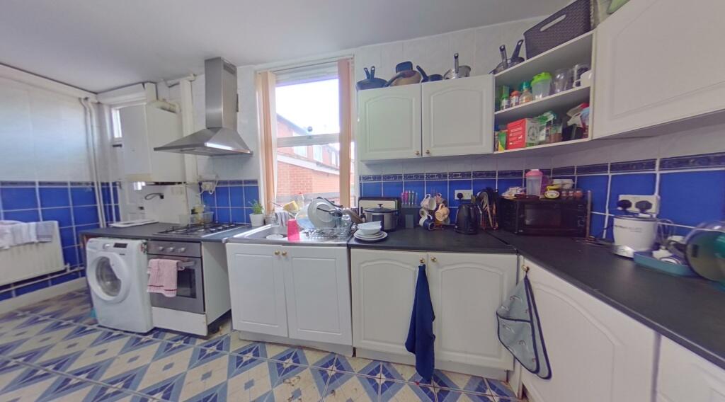 Bright and airy kitchen featuring modern applia...