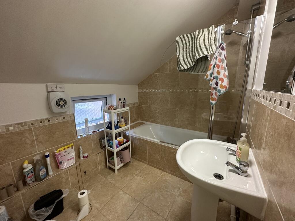 A well-maintained bathroom featuring a bath and...